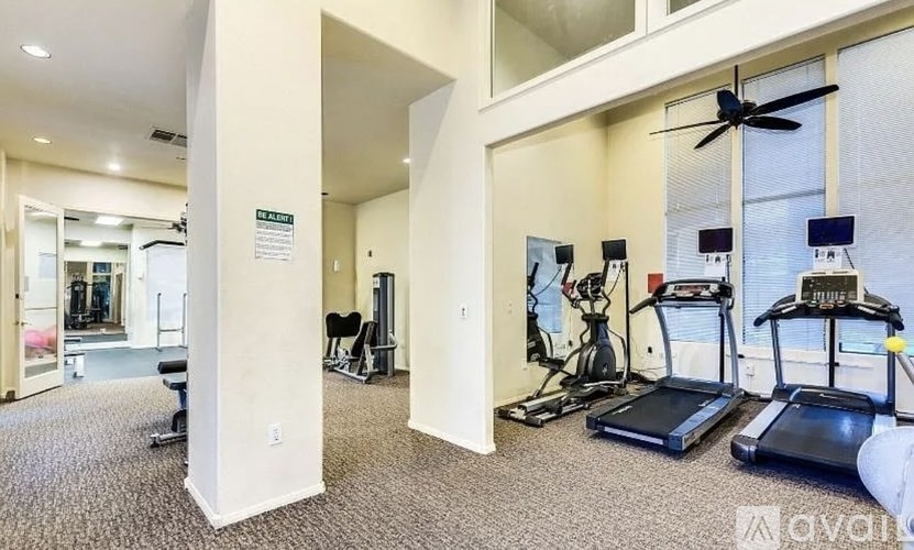 A gym with treadmills, exercise bikes, and other equipment.