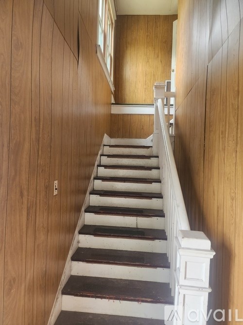 A staircase with wooden steps and white railings.