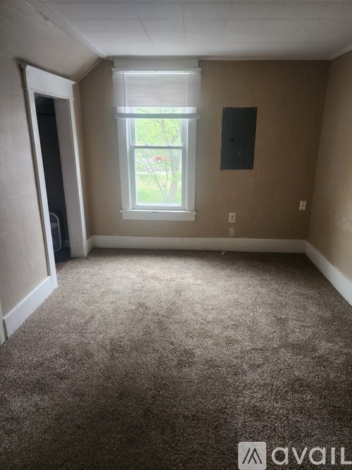 A room with a window and a door.