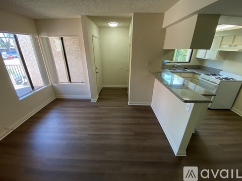 A kitchen with a countertop and cabinets is available for rent.