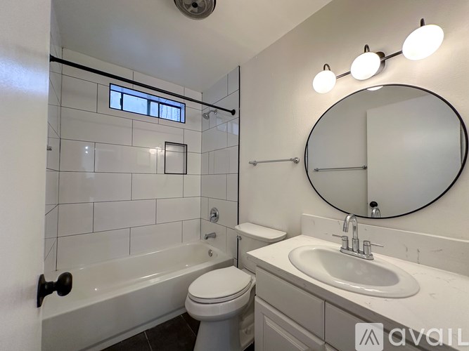 A bathroom with a toilet, sink, and bathtub.