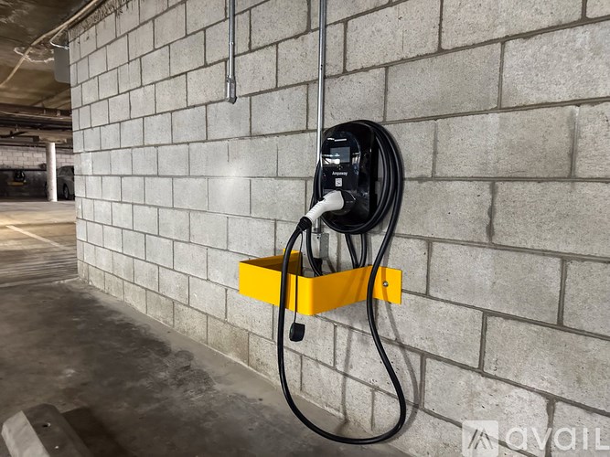 A black power strip plugged into a wall socket.