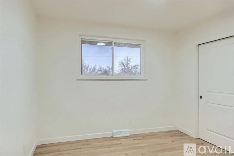 A room with a window and a door.