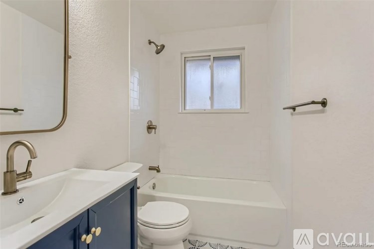A bathroom with a white tub, toilet, and sink.