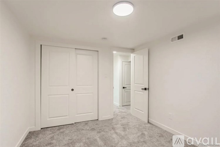A white door is closed in a room with a carpet floor.
