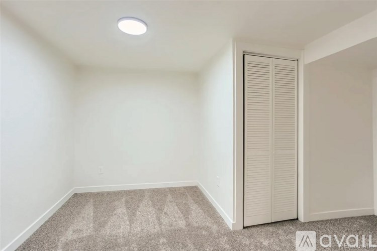 A room with a carpeted floor and a closed door.