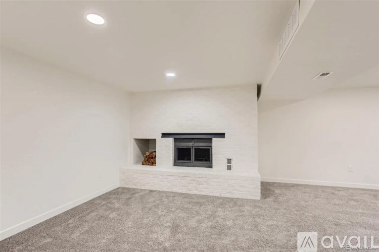 A room with a fireplace and carpeted floor.