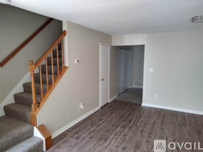 A room with a staircase and a door.