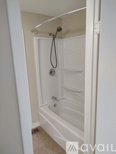 A white bathroom with a tub and shower.