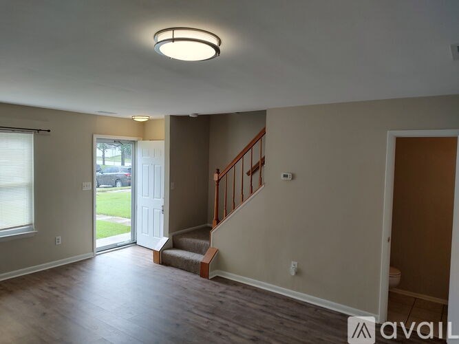 A living room with a staircase leading to the upper floor.