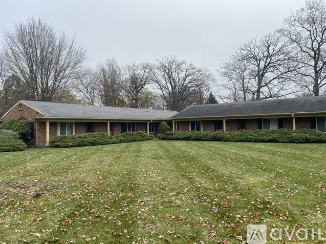 A house with a grey roof and a green lawn in front.