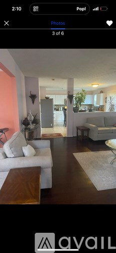 A living room with a white couch and a coffee table.