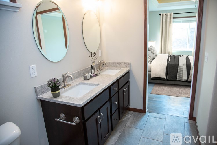 A bathroom with a sink, mirror, and toilet.