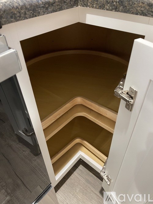 A white cabinet with a drawer is open.