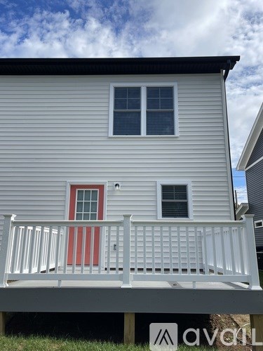 A house with a red door and a white porch.