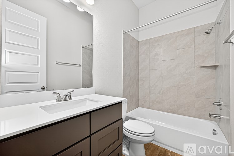 A bathroom with a white sink and a white toilet.