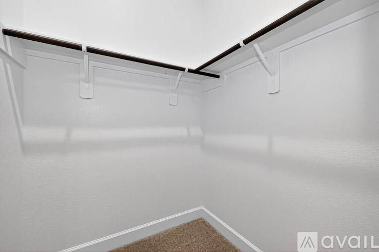 A white refrigerator with a brown carpet on the floor.