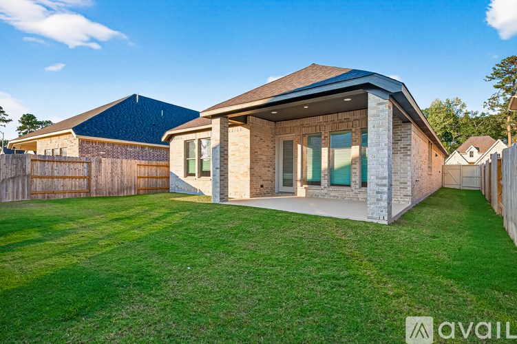 A house with a blue roof and a green lawn in front.