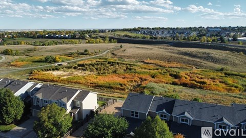 A row of houses with a field in the foreground.