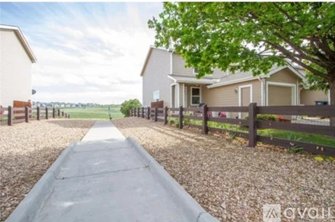 A residential area with houses and a gravel path.