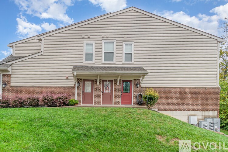 A house with a red door and a brick wall.