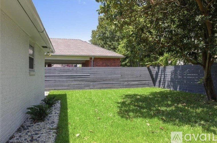 A house with a green lawn in front.