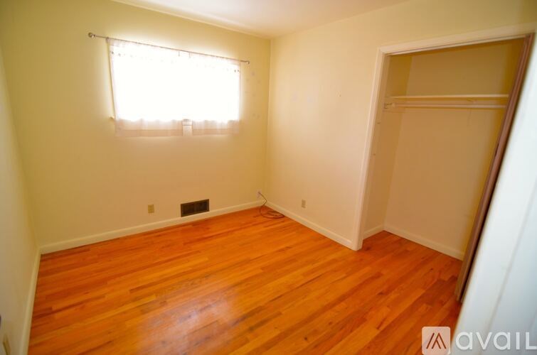 A room with wooden floors and a window.