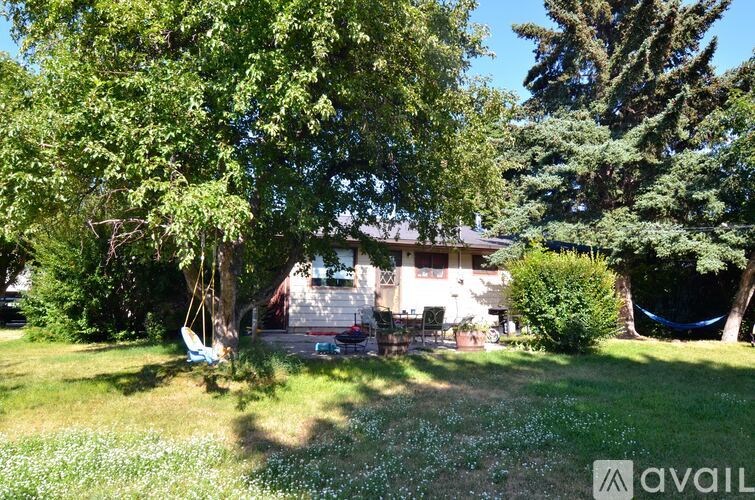 A house is surrounded by trees and grass.