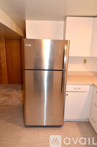 A stainless steel refrigerator in a kitchen.