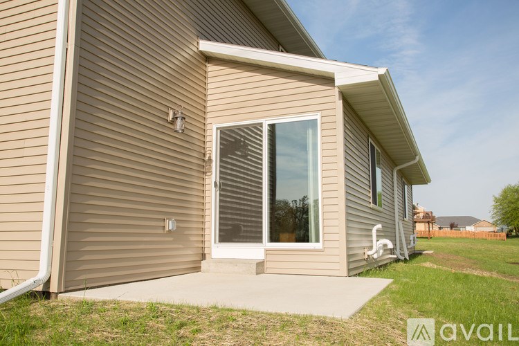 A house with a beige siding and a window with blinds.