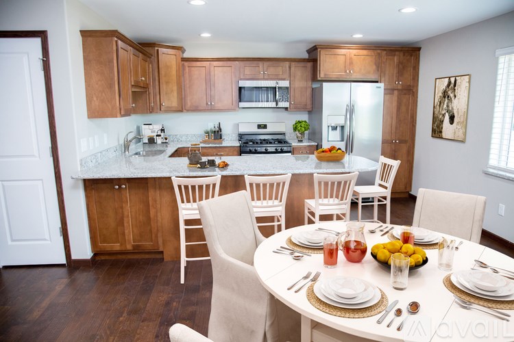 A kitchen with a table set for a meal.