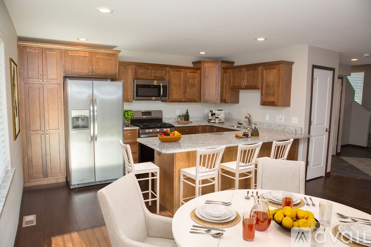 A kitchen with a table set for a meal.