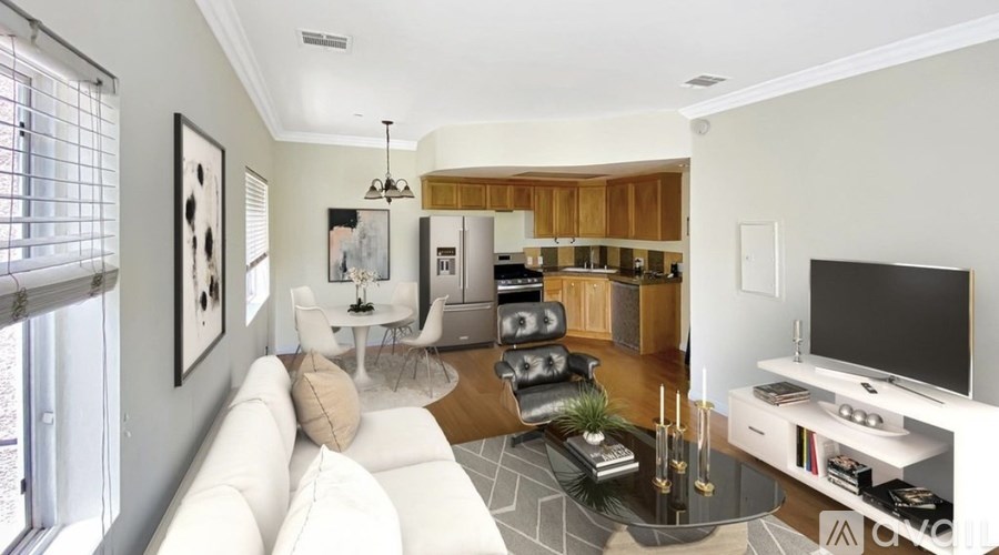 A modern living room with a white sofa and a television.