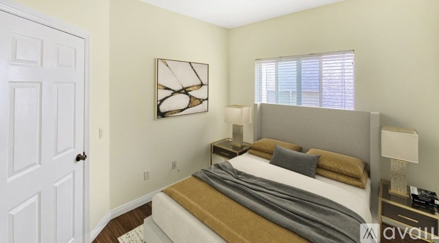 A bedroom with a large bed and a white door.