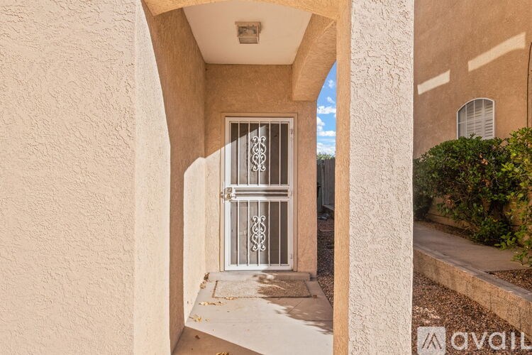 A white gate is on a white door.