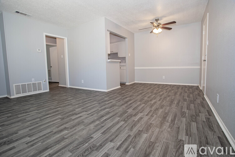 A kitchen area with a refrigerator, cabinets, and a countertop.