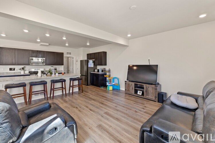 A modern living room with a bar area and a television.