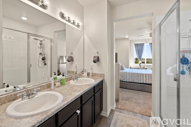 A bathroom with a double sink vanity and a large mirror.