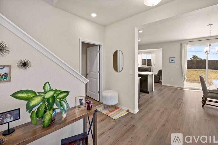 A living room with a staircase and a couch.
