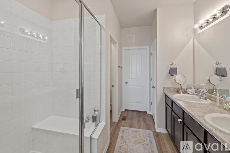 A bathroom with a white tub and sink.