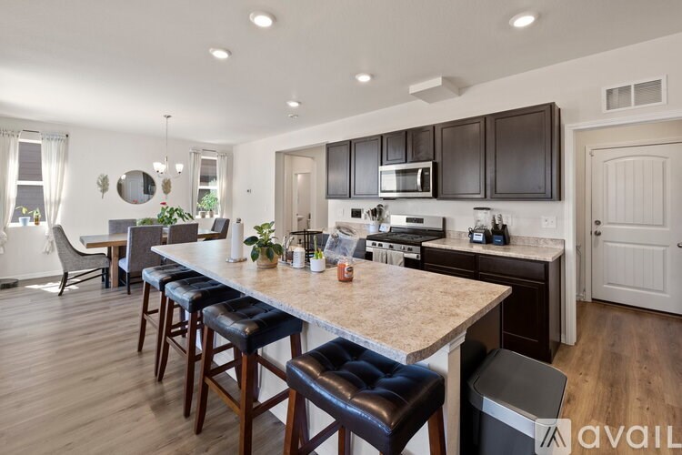 A kitchen with a bar area and a dining table.