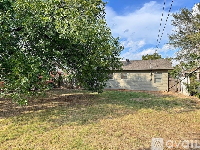 A house with a tree in front of it.