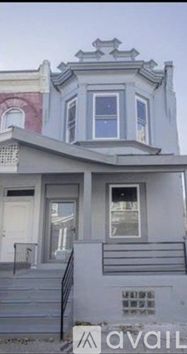 A two-story house with a balcony on the second floor.