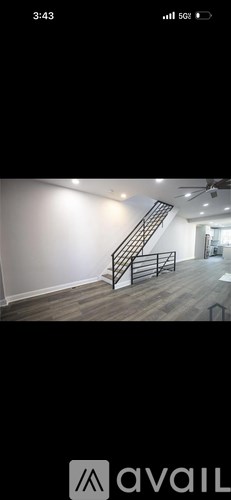 A staircase with a metal railing and wooden steps.