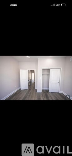 A room with wooden floors and white walls.