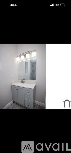 A bathroom with a vanity and mirror.