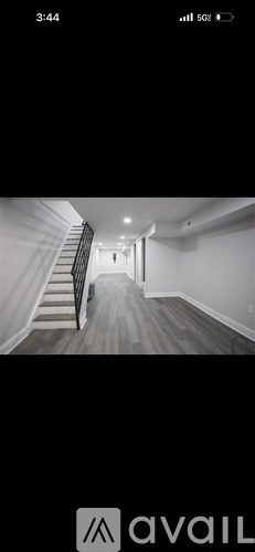 A long hallway with a staircase on the left side.