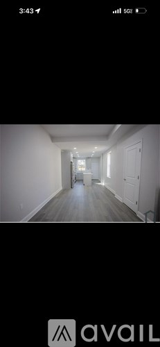 A hallway with a white door at the end.