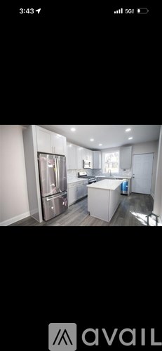 A modern kitchen with stainless steel appliances and a large island.