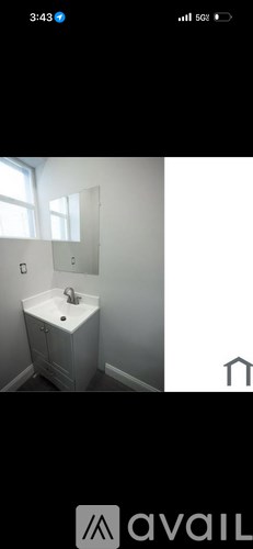 A small white bathroom with a sink and mirror.